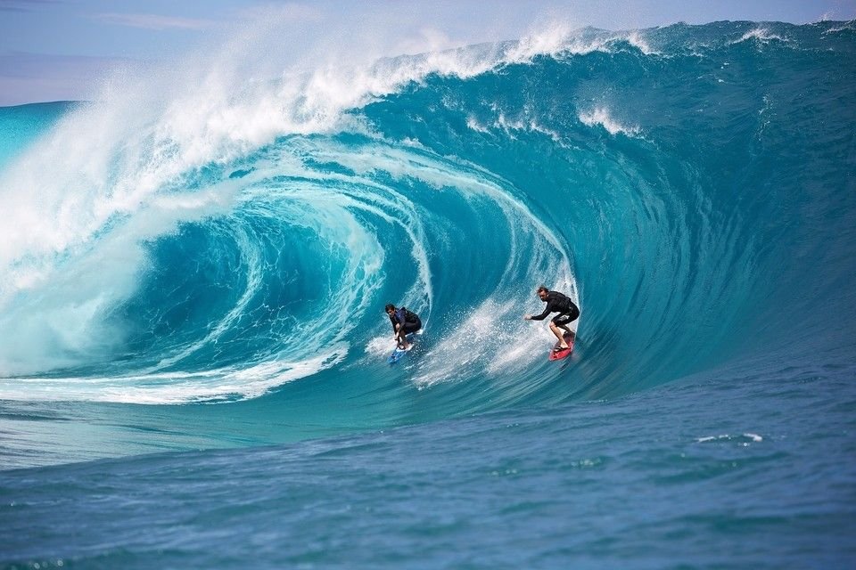Surfer riding waves at Cloud 9 in Siargao Island